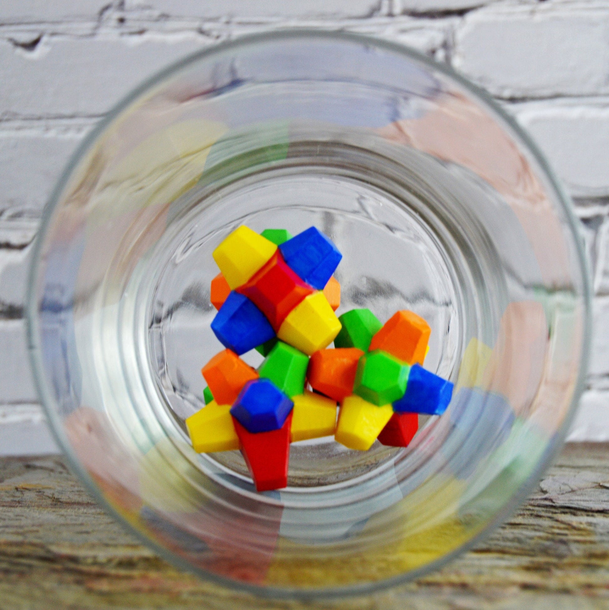 Three gobstoppers in a glass bowl.