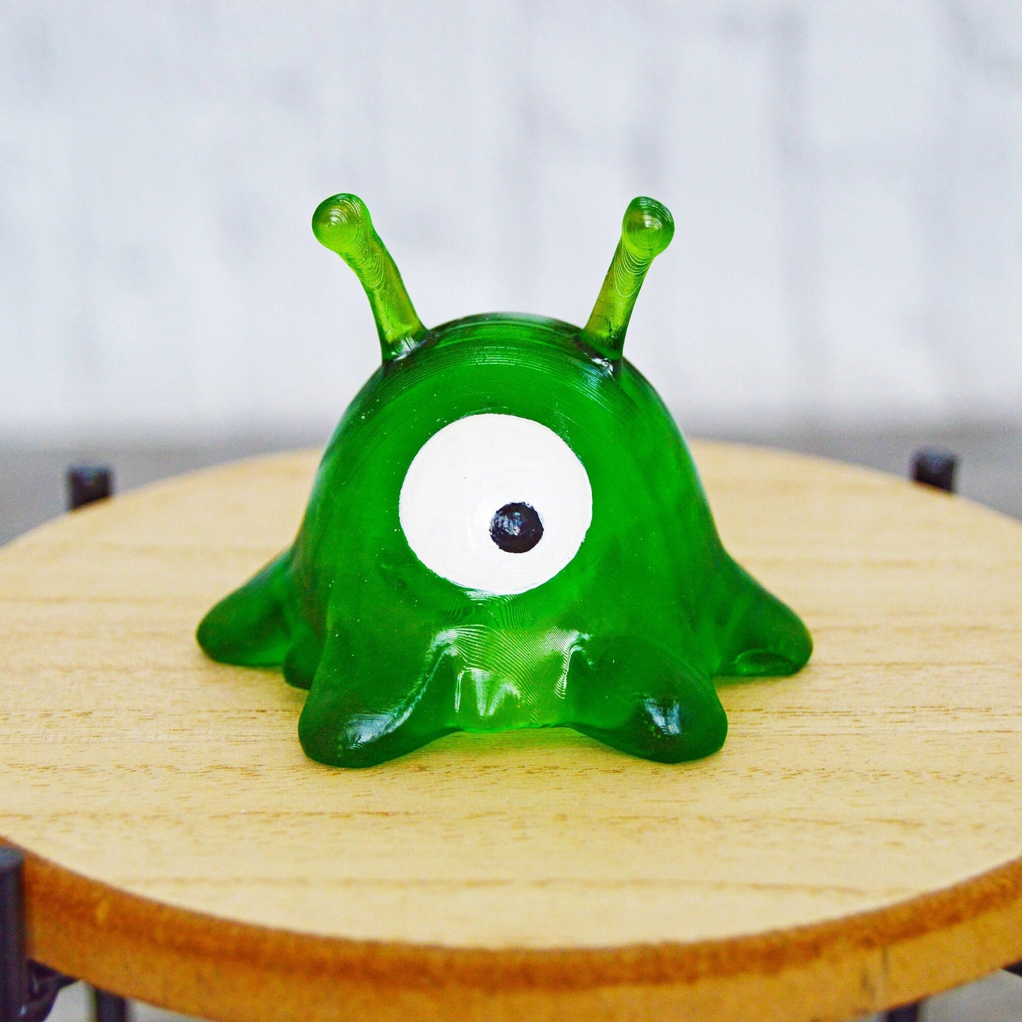 This is a 3D printed, translucent green resin, one eyed, small alien with two antennae from the TV show Futurama. It is only 1.5 inches tall.