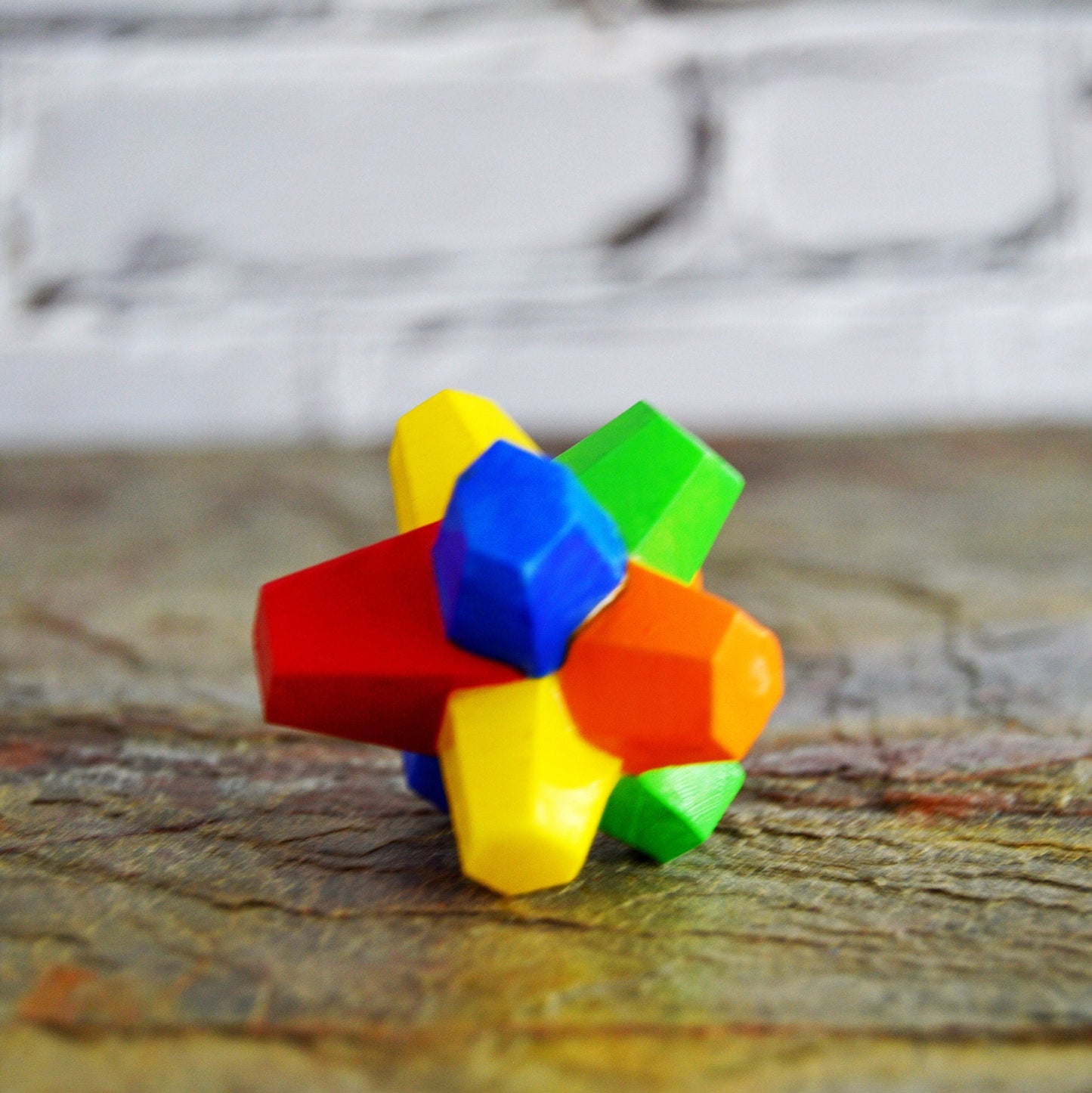 The gobstopper is very brightly colored, using yellow, orange, red, blue, and green acrylic paint. This gobstopper is 3D printed using resin. It is solid and has a good weight to it.