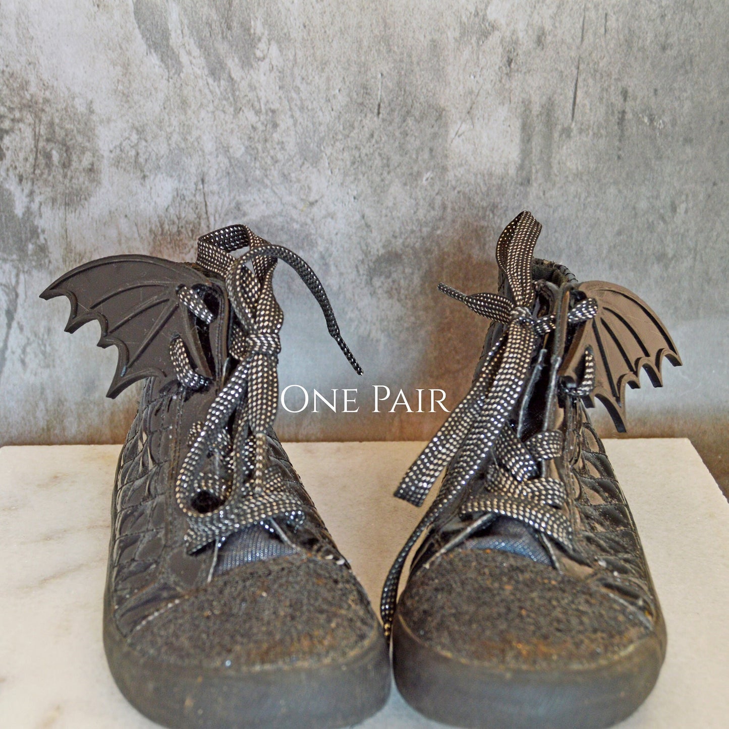 With one pair of wings, wear a wing on the outside of each shoe.