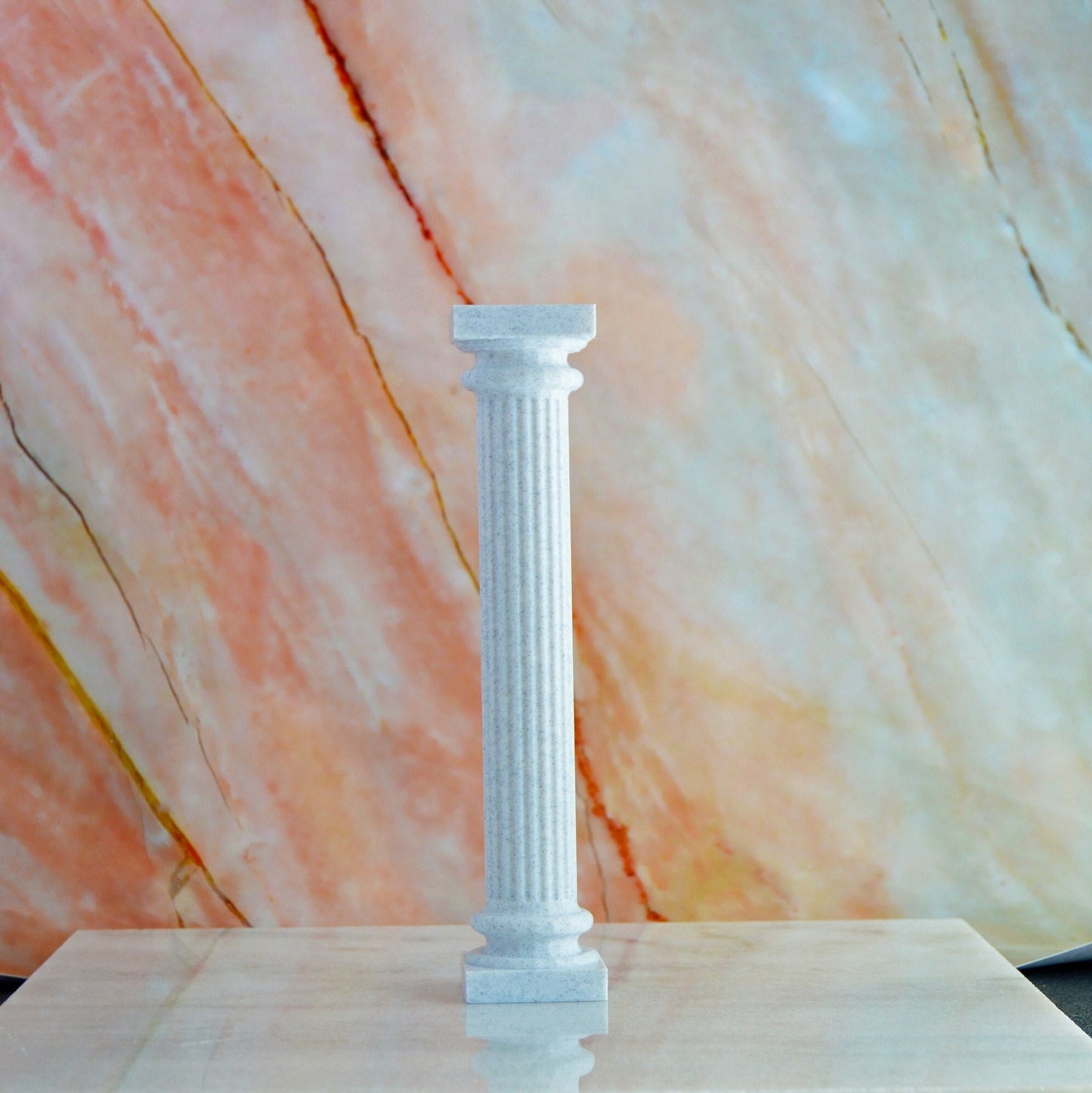 This is a 3D printed picture of a classic Greek pillar or column. It is printed using marble filament to give it an off white marble look with black/gray specks in it to look like the marbling effect.